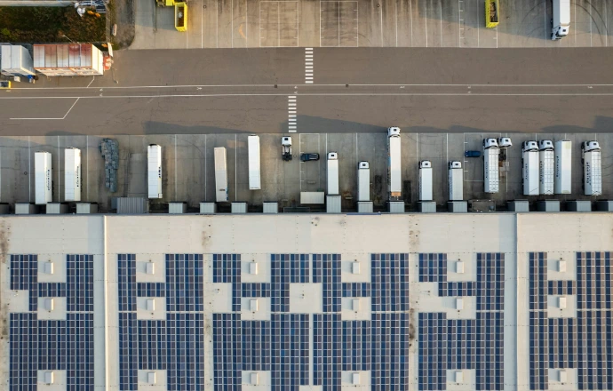 An aerial view of a parking lot with cars